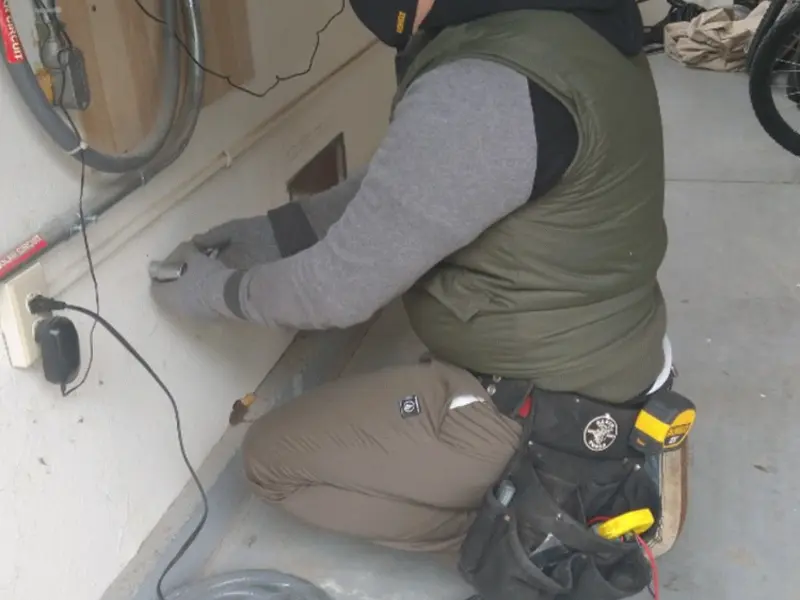 Electrician performing outlet wiring in a Boyes Hot Springs garage